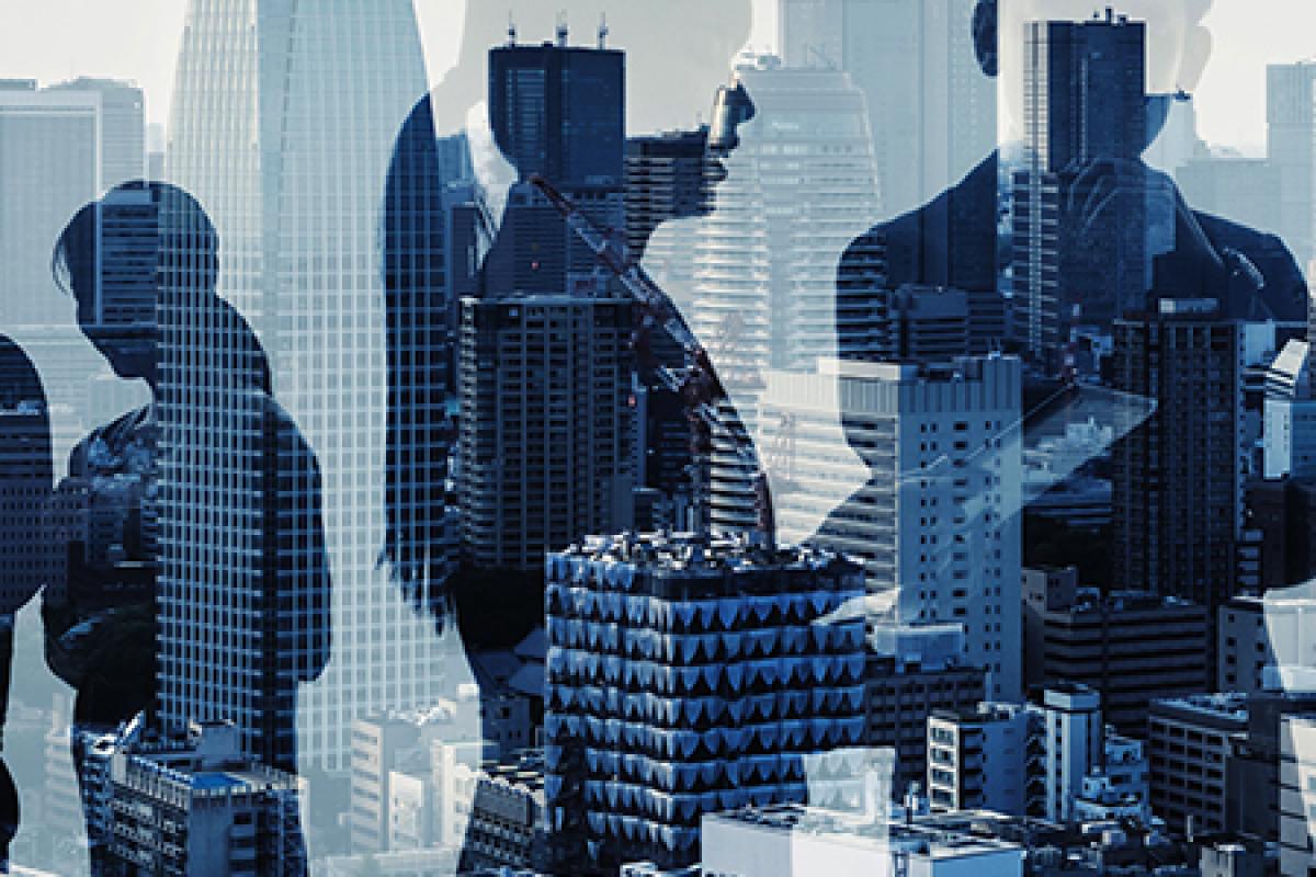 A city skyline with business people discussing
