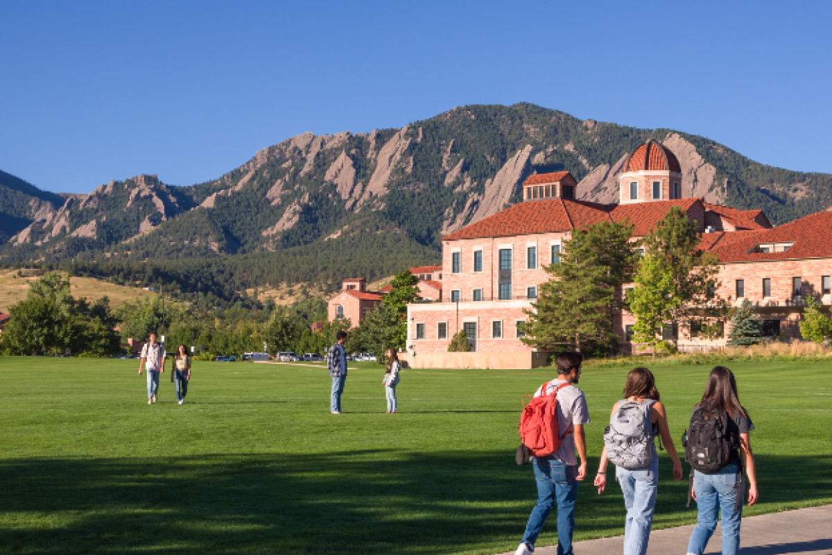 Koelbel and Flatirons with students walking