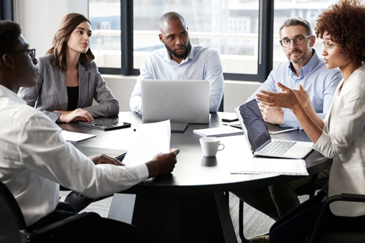 Diverse group of professionals collaborates around a table