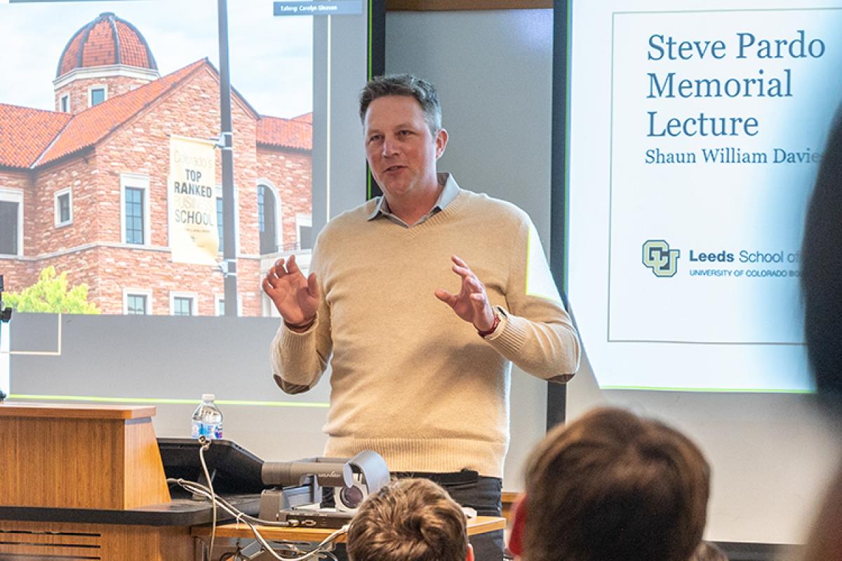 Shaun teaching in a lecture hall. Perspective is from a student near the back of the room.