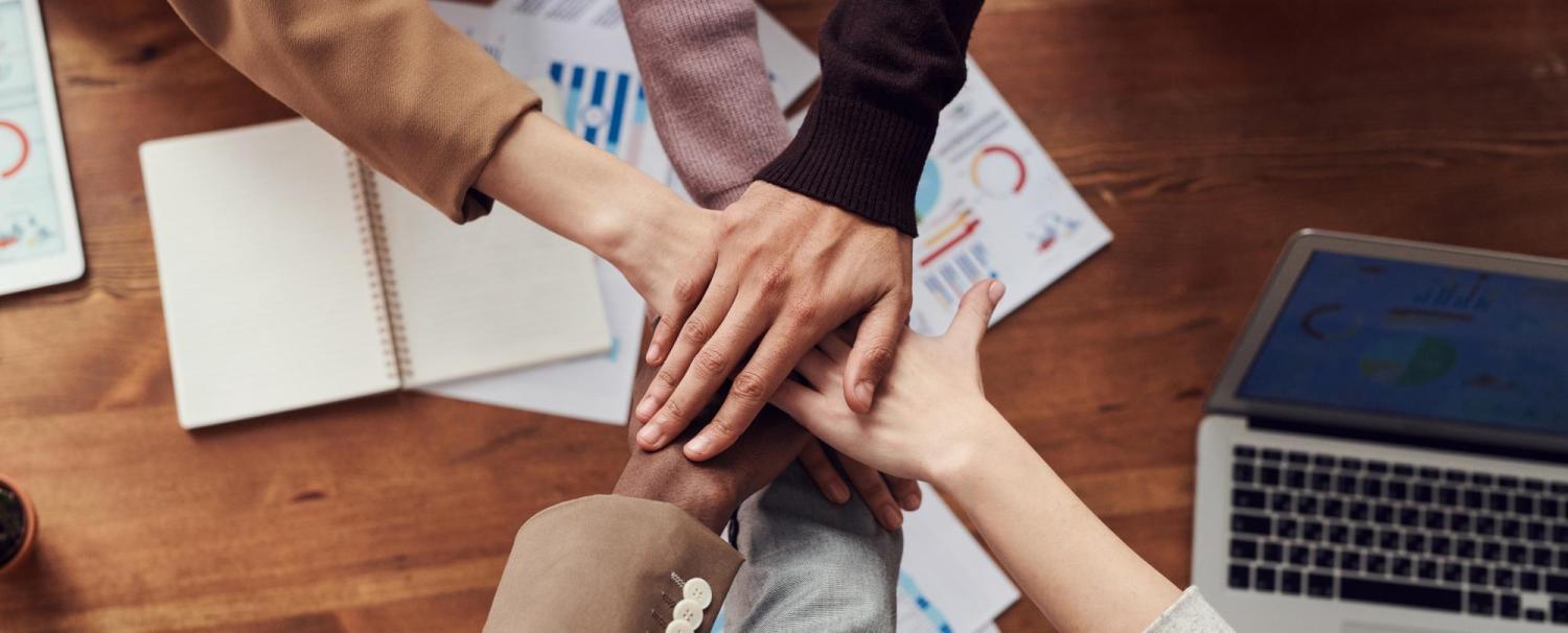 image of hands together, representing DEI and teamwork