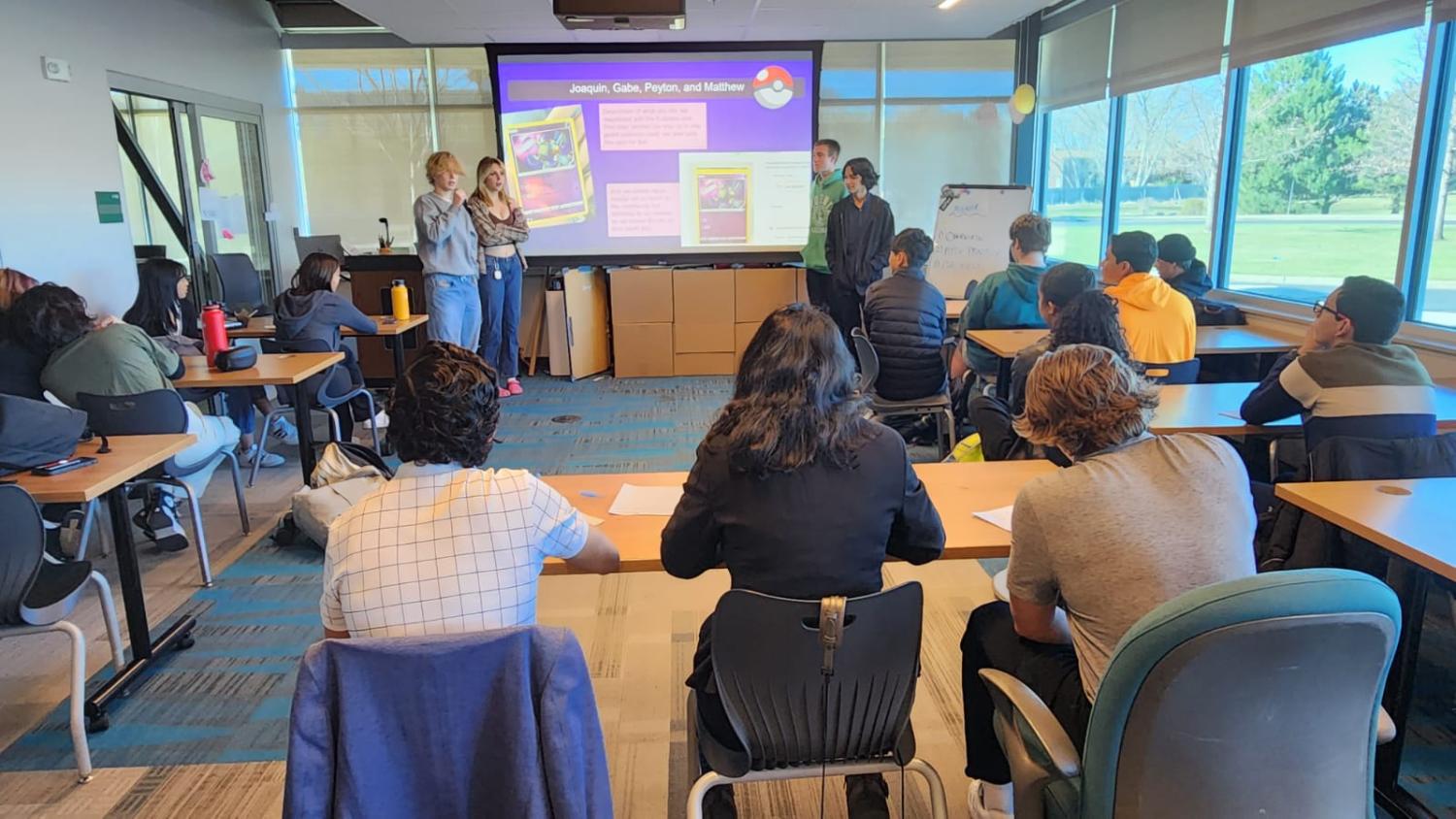 Students and judges at the Peak-to-Peak $5 Challenge watching a team of students present.