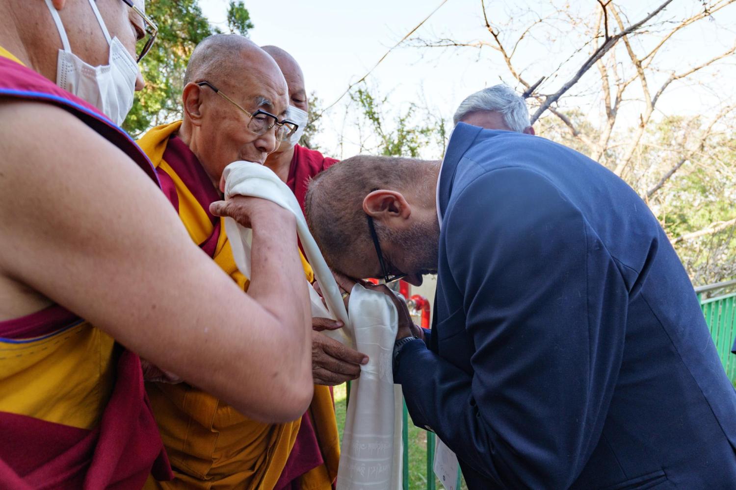 Leeds Dean Vijay Khatri bows while meeting the Dalai Lama