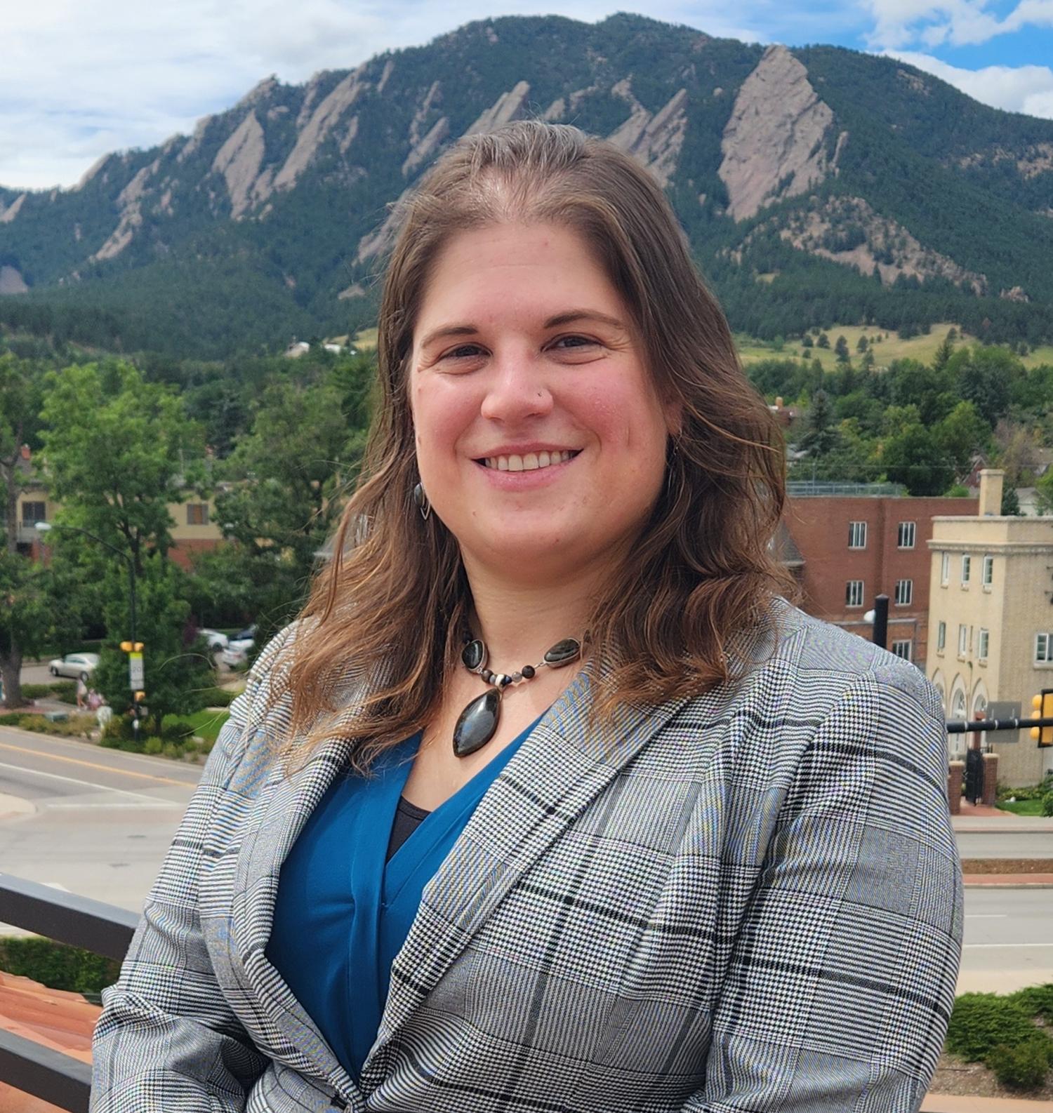 Annette De Capite photographed in front of the Boulder Flatirons