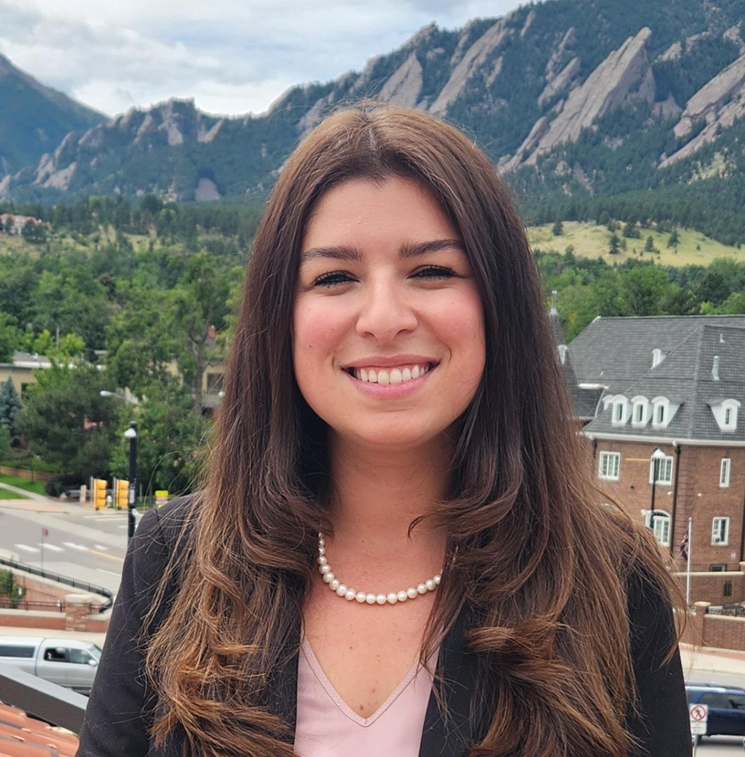 photo of Bek Coelho against the Flatirons of Boulder at CU