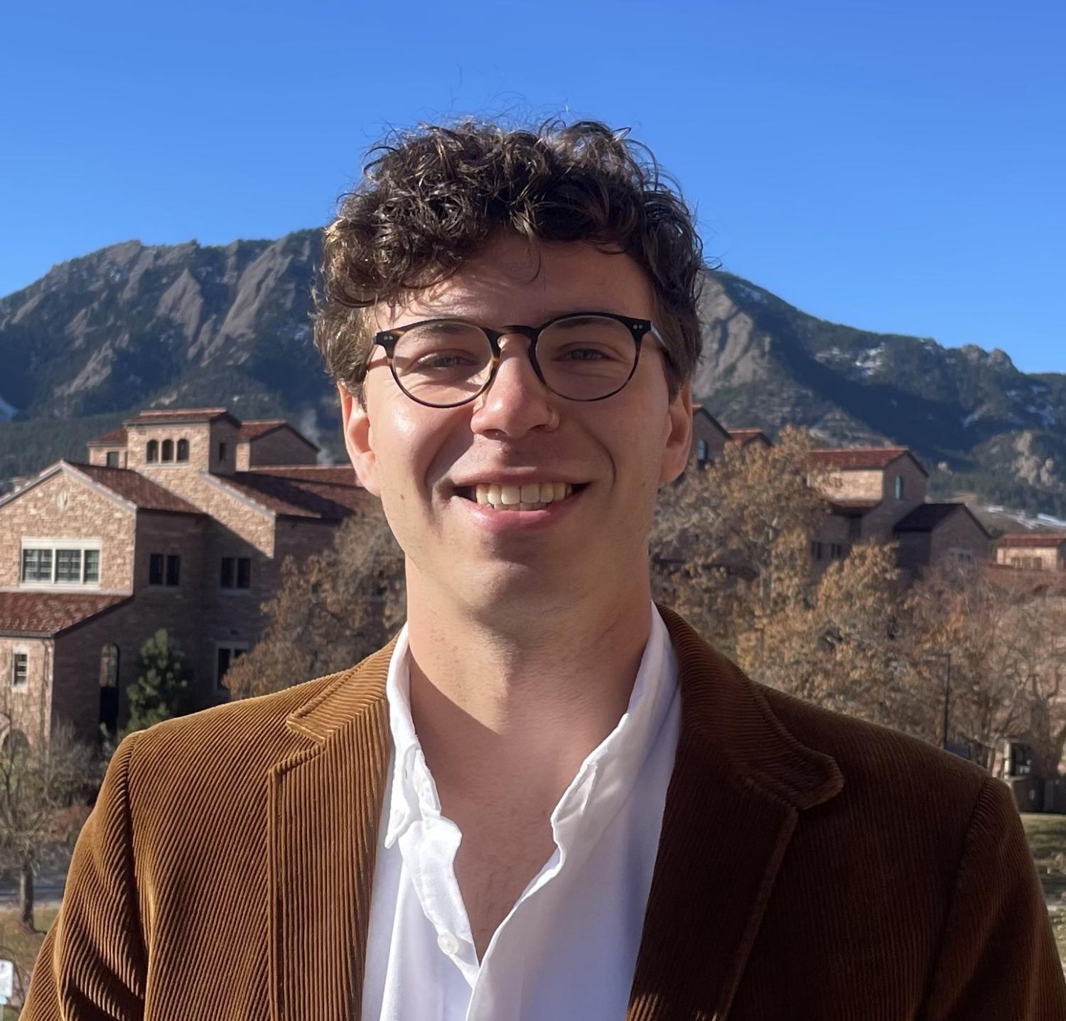 Photo of Ethan in front of Boulder flatirons