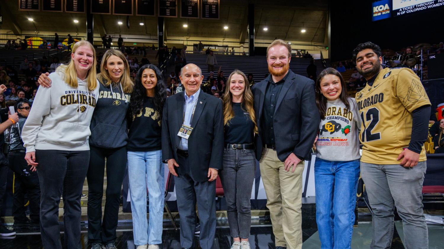 2025 Graduating Leader of the Year winners pose on the basketball court with Chancellor DiStefano