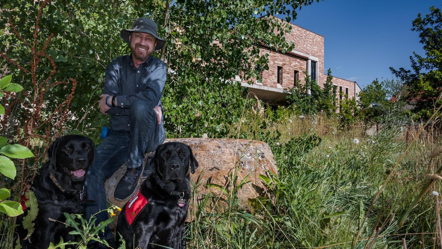 Erick Mueller with his dogs, Auggie and Khaya