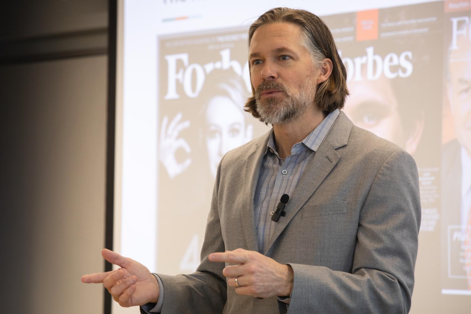Matthew Brady addresses student during an event