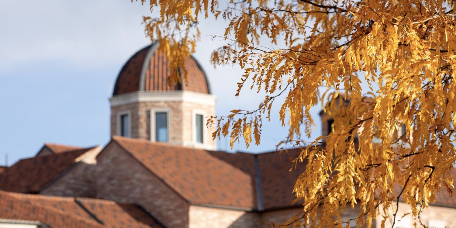 Koelbel Building dome with fall foliage in the foreground