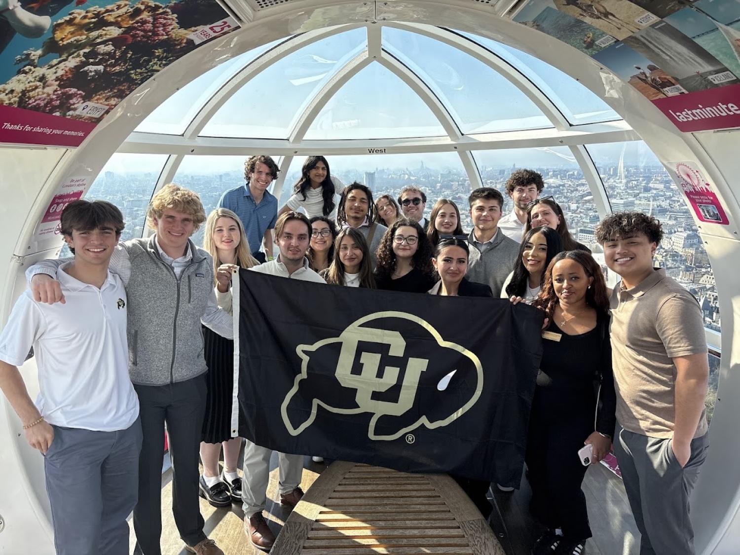 Students pose with a CU flag in the London Eye