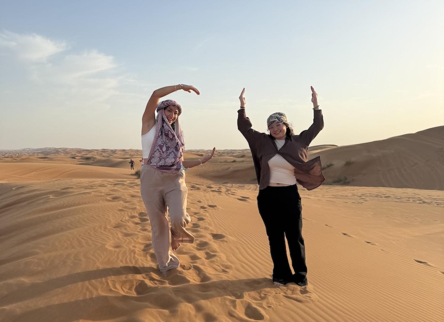 Two students in the desert on an FGX Dubai 2025 trip