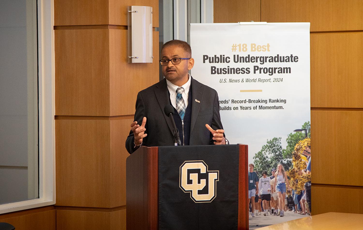 Dean Vijay Khatri speaks from a podium during Leeds Media Day.