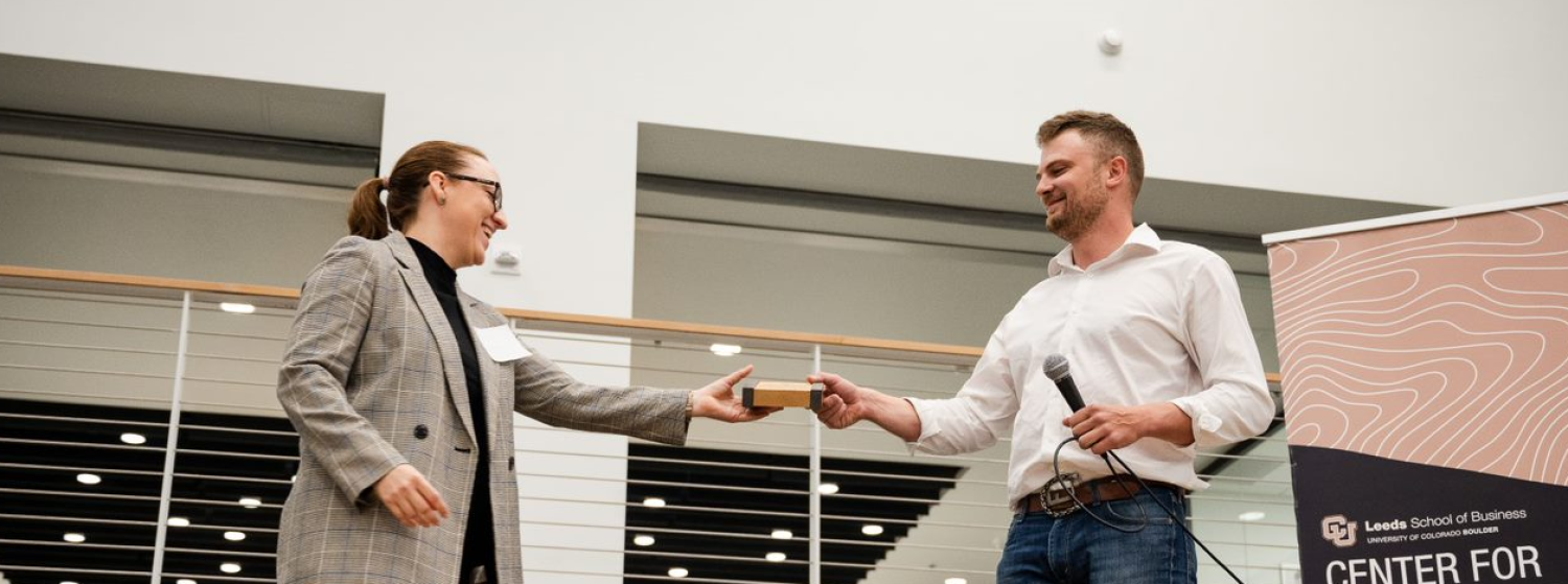 ESG MBA Anna Reves receiving Impact Business Buff award from Chris Fogler at Leeds School of Business