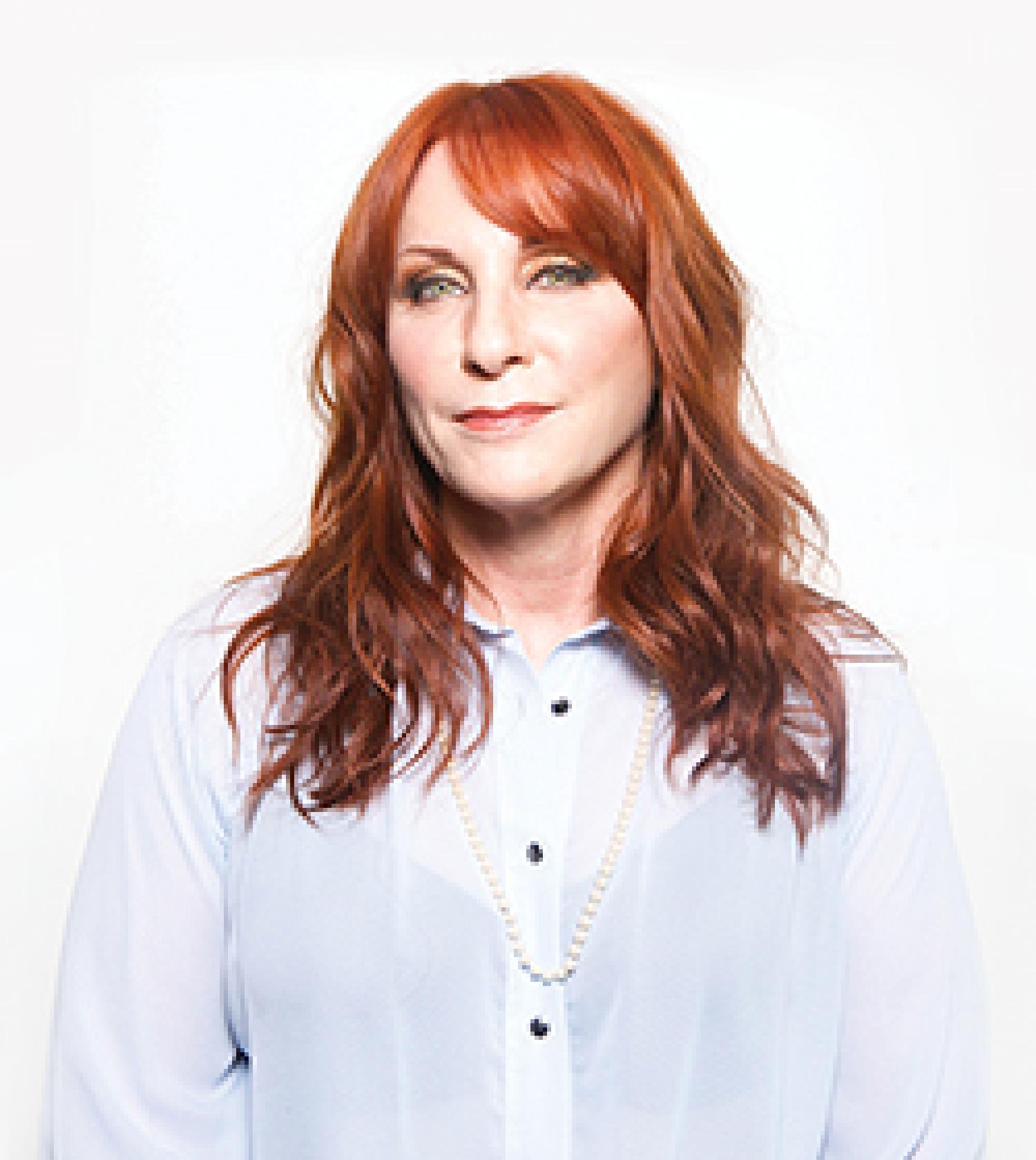 Beth Ann Catalano poses against a stark white background.