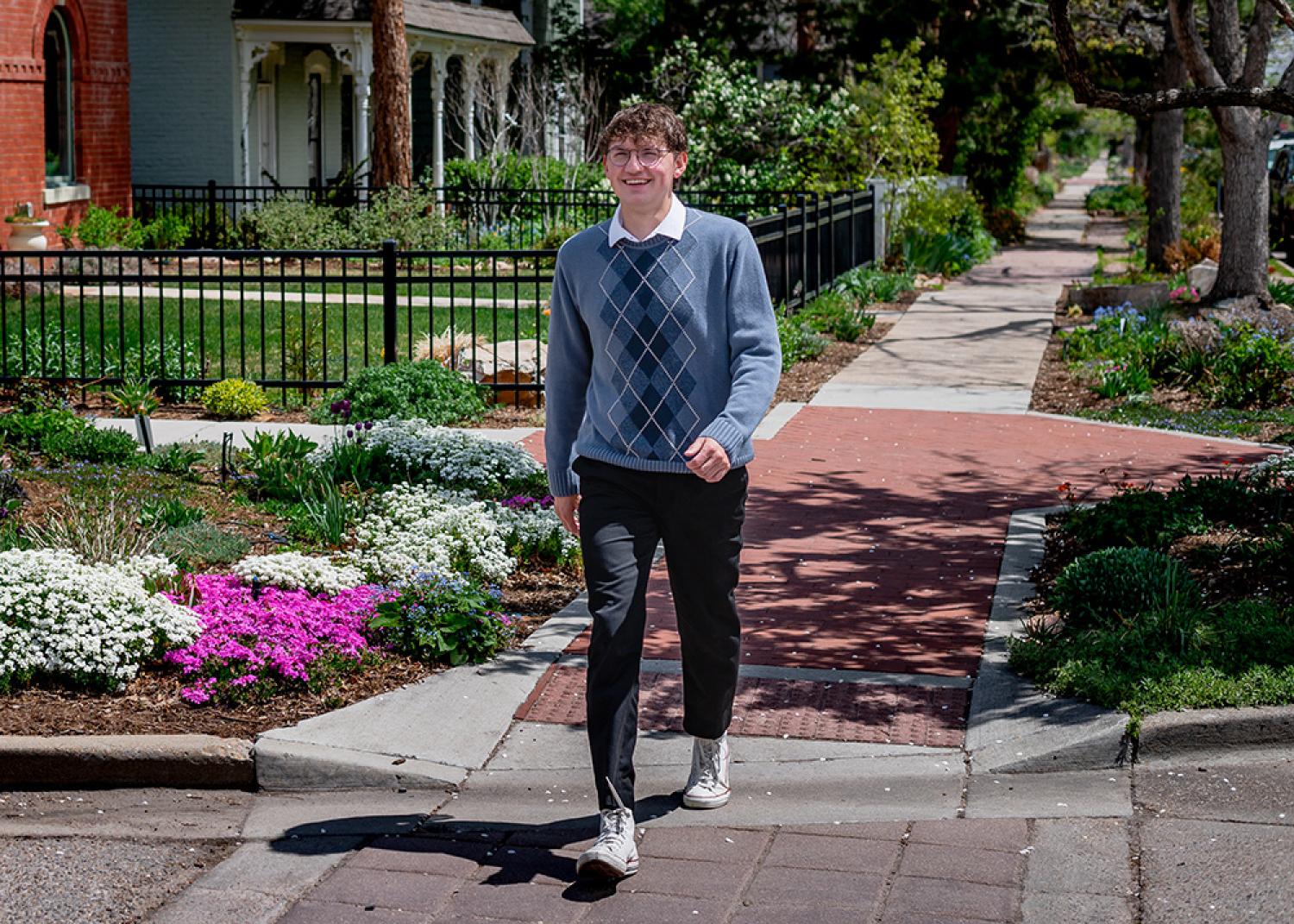 Carter Snelson smiles while he walks across a Boulder street.