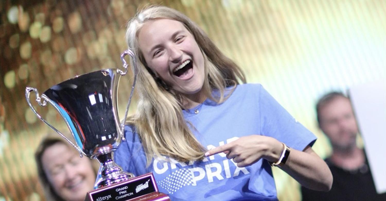 Claire McCollough celebrates with the trophy at the Alteryx competition.