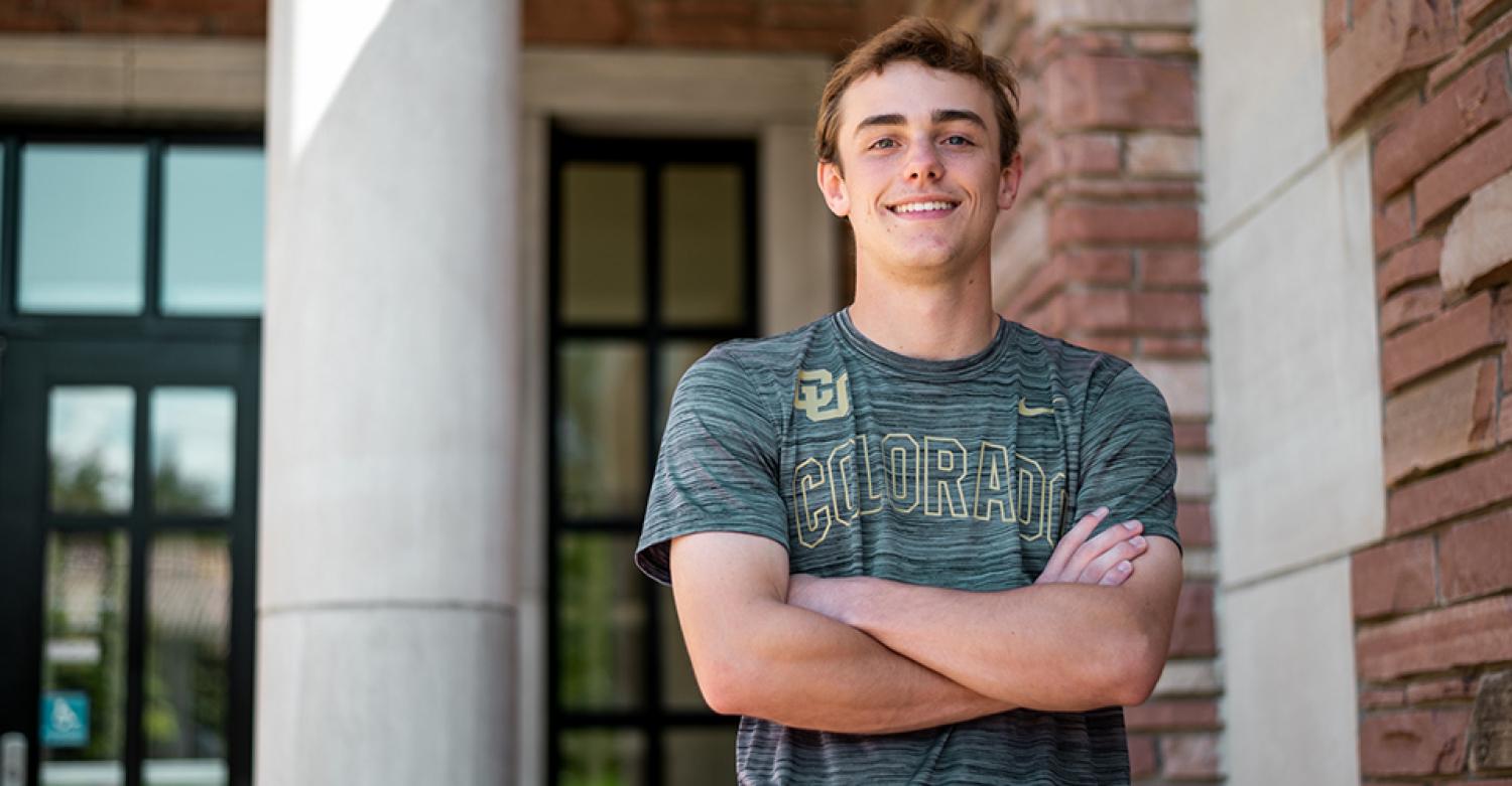 Carson Carere poses outside the Loelbel Building on a sunny day.