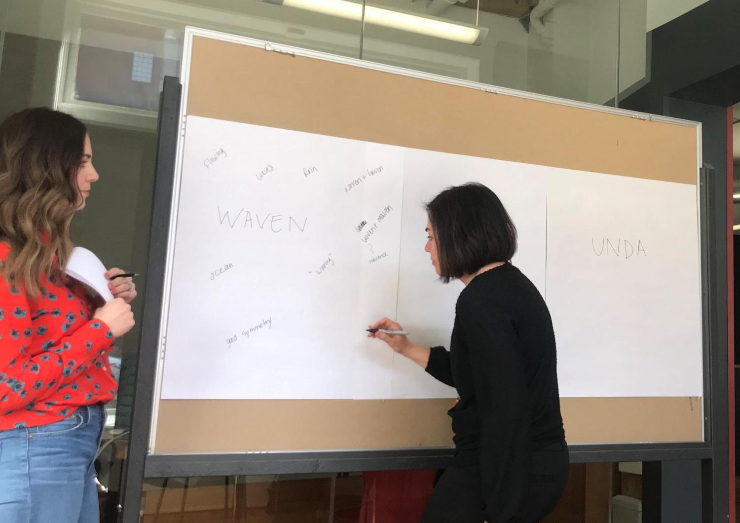 Woman writing on a board