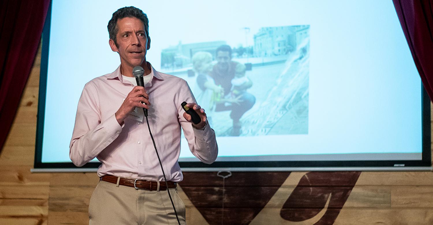 David Drake leads a talk from the front of a bar in downtown Boulder.