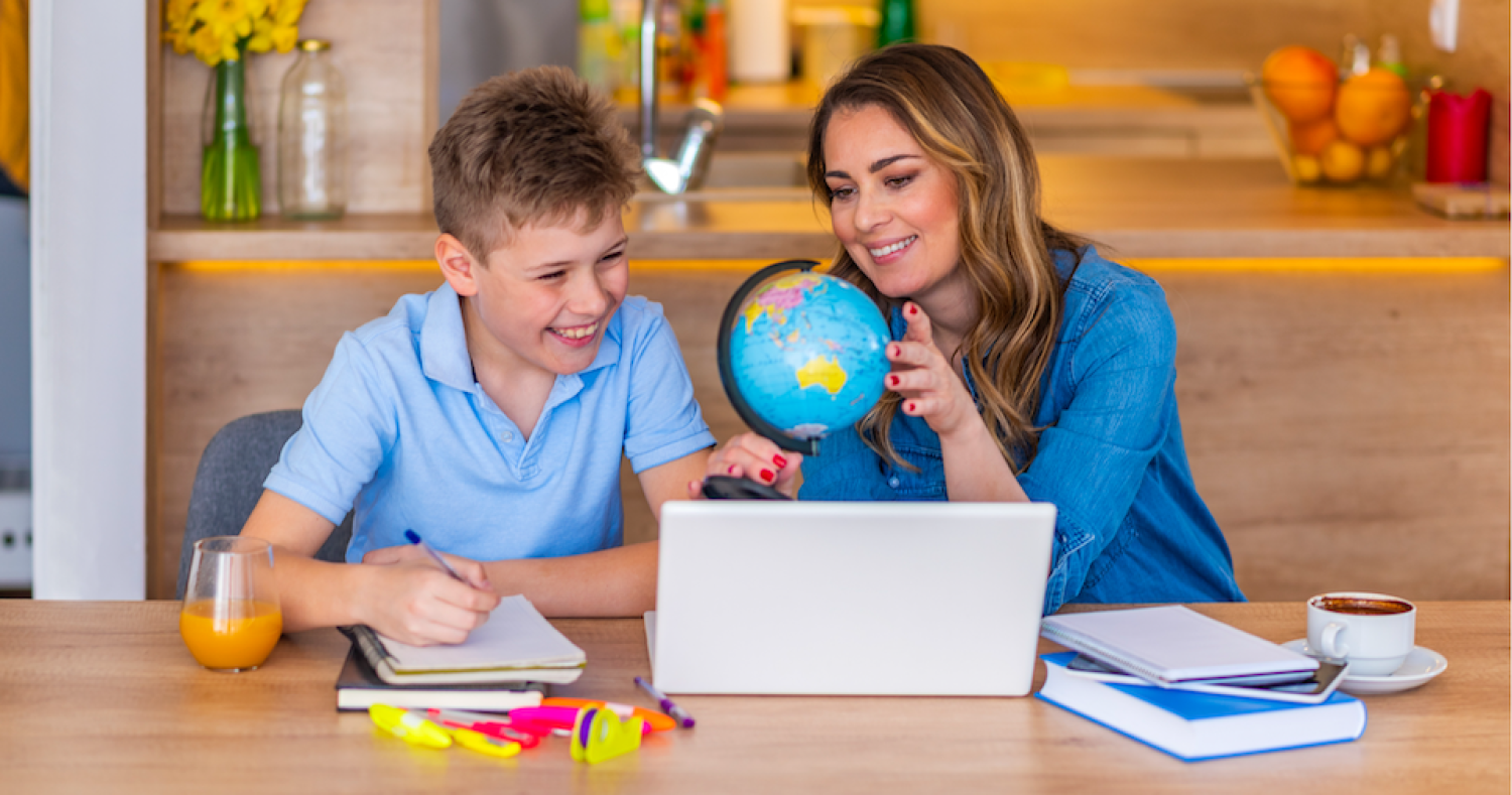 Image of woman and a child look at a globe
