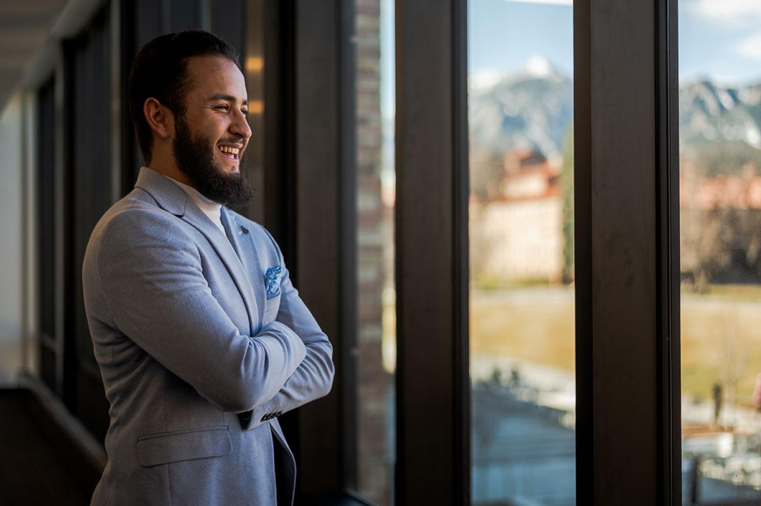 Fawad Ahmadzai chuckles while gazing out a window in the Rustandy Building.