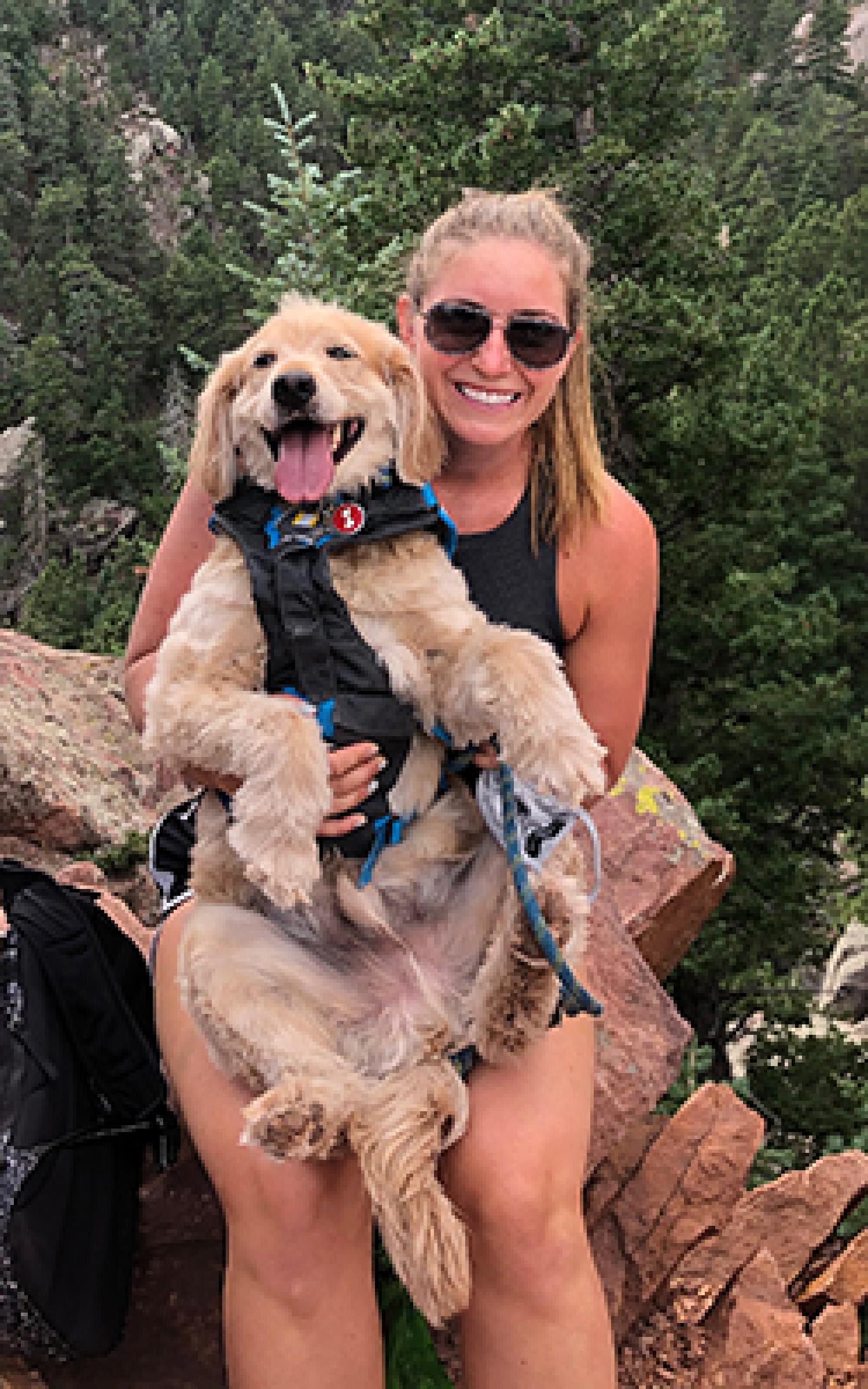 Amber Hughes on a forest hiking trail with her puppy.