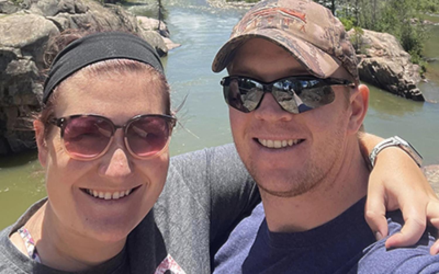 Laurel Harman takes a selfie in a mountain park next to her husband.