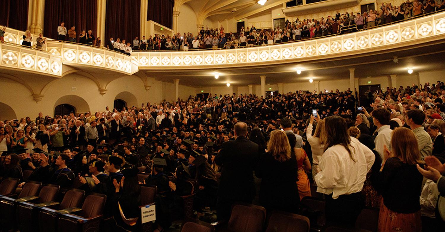 Graduates in a packed Macky Auditorium