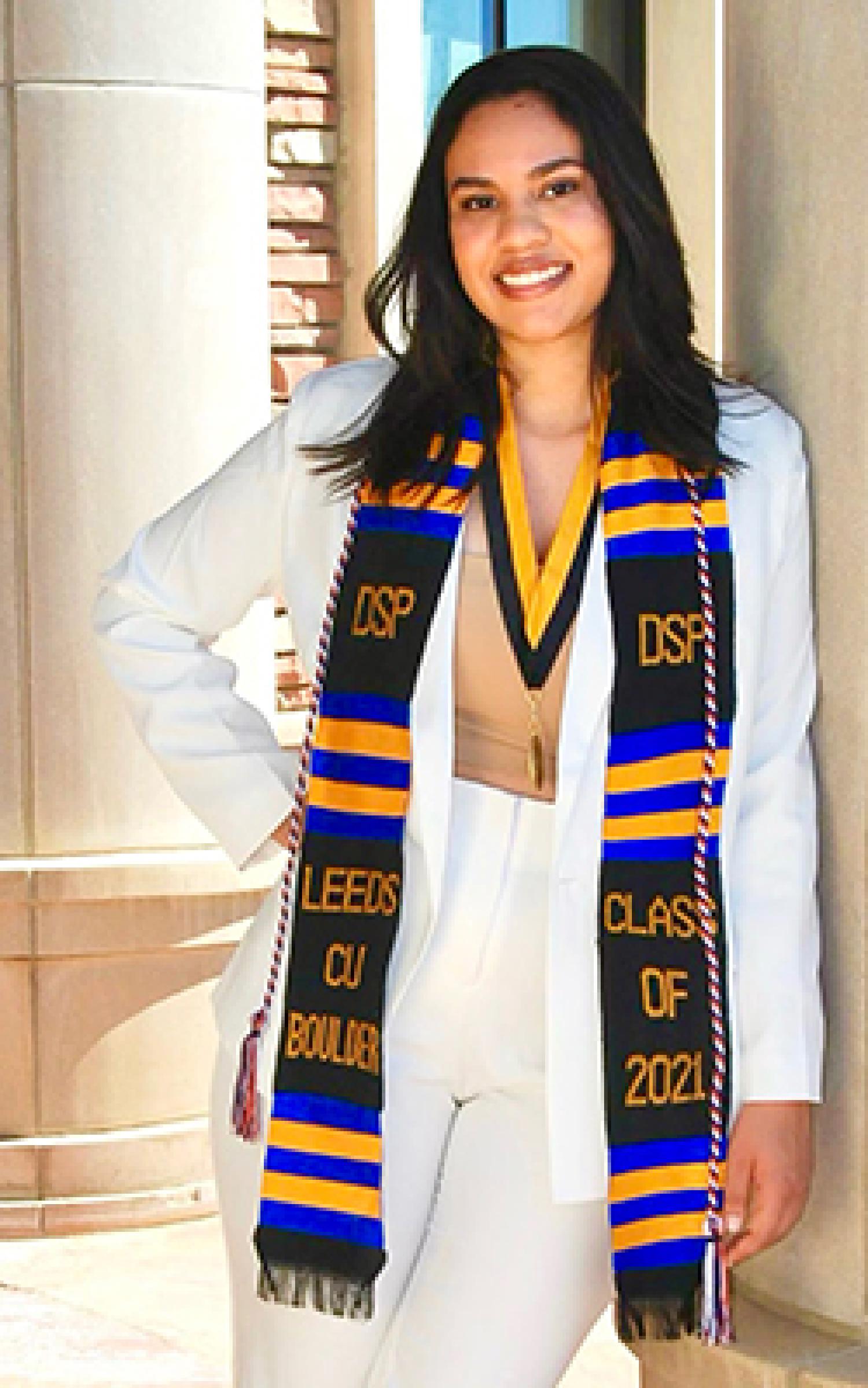 Jordyn in her graduation regalia and Diverse Scholars Program hood.