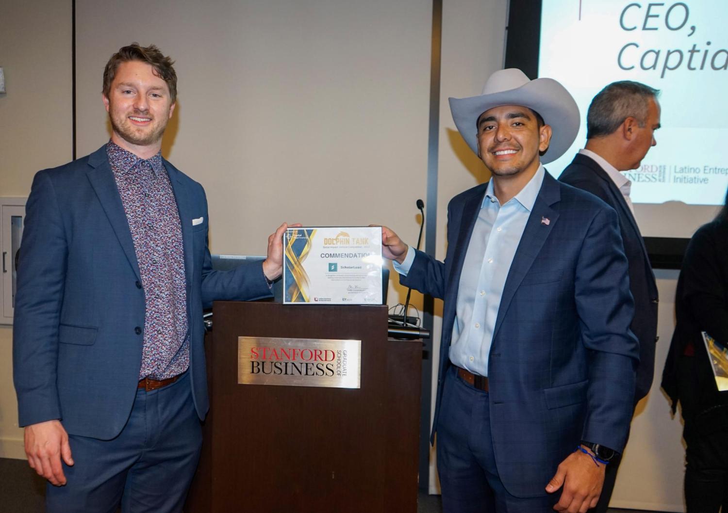 Nick Brown (left) and Uriel Berrum (right) holding their Dolphin Tank award
