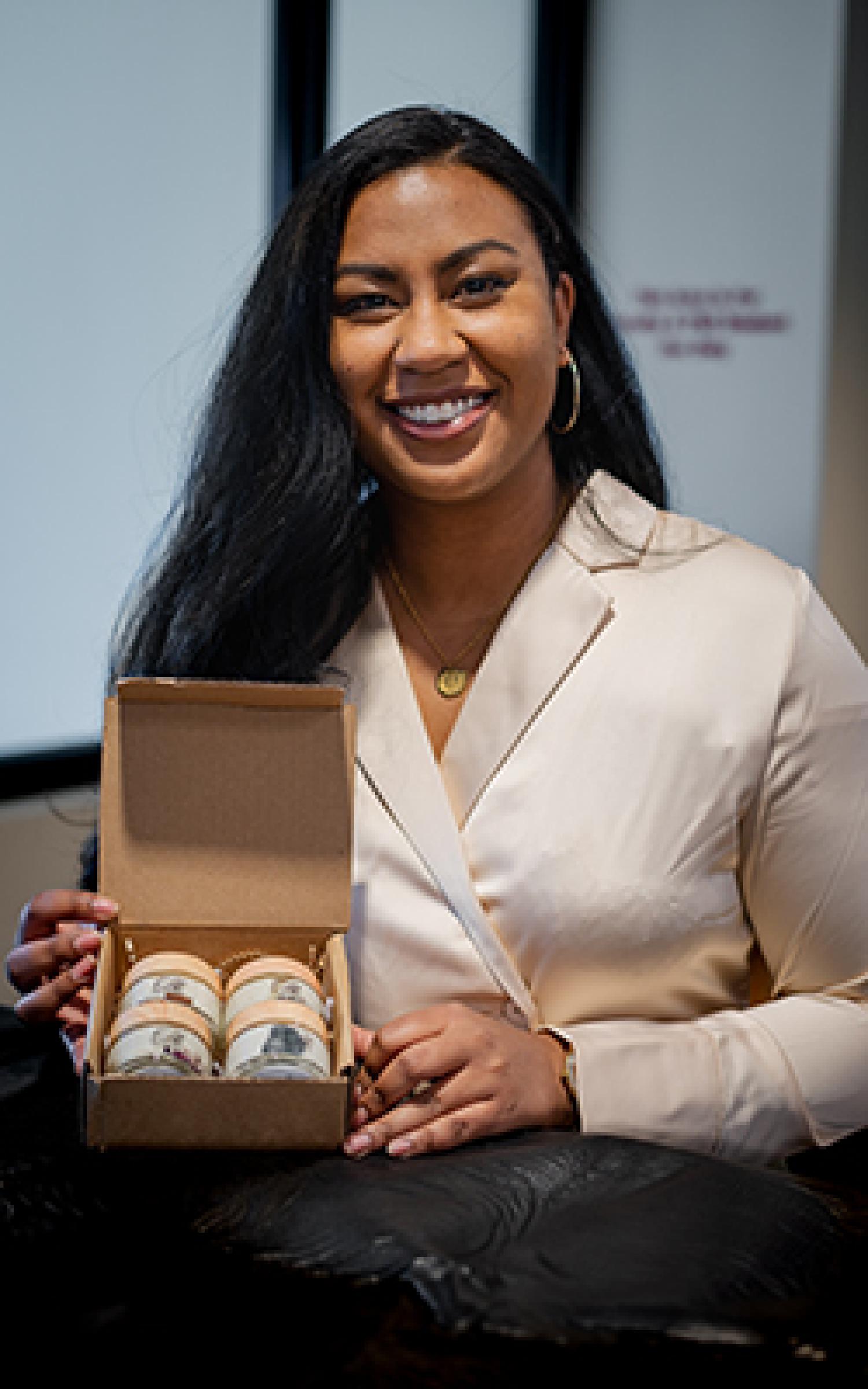 Laura Moore seated at a table with a box of her Silk By Laura products