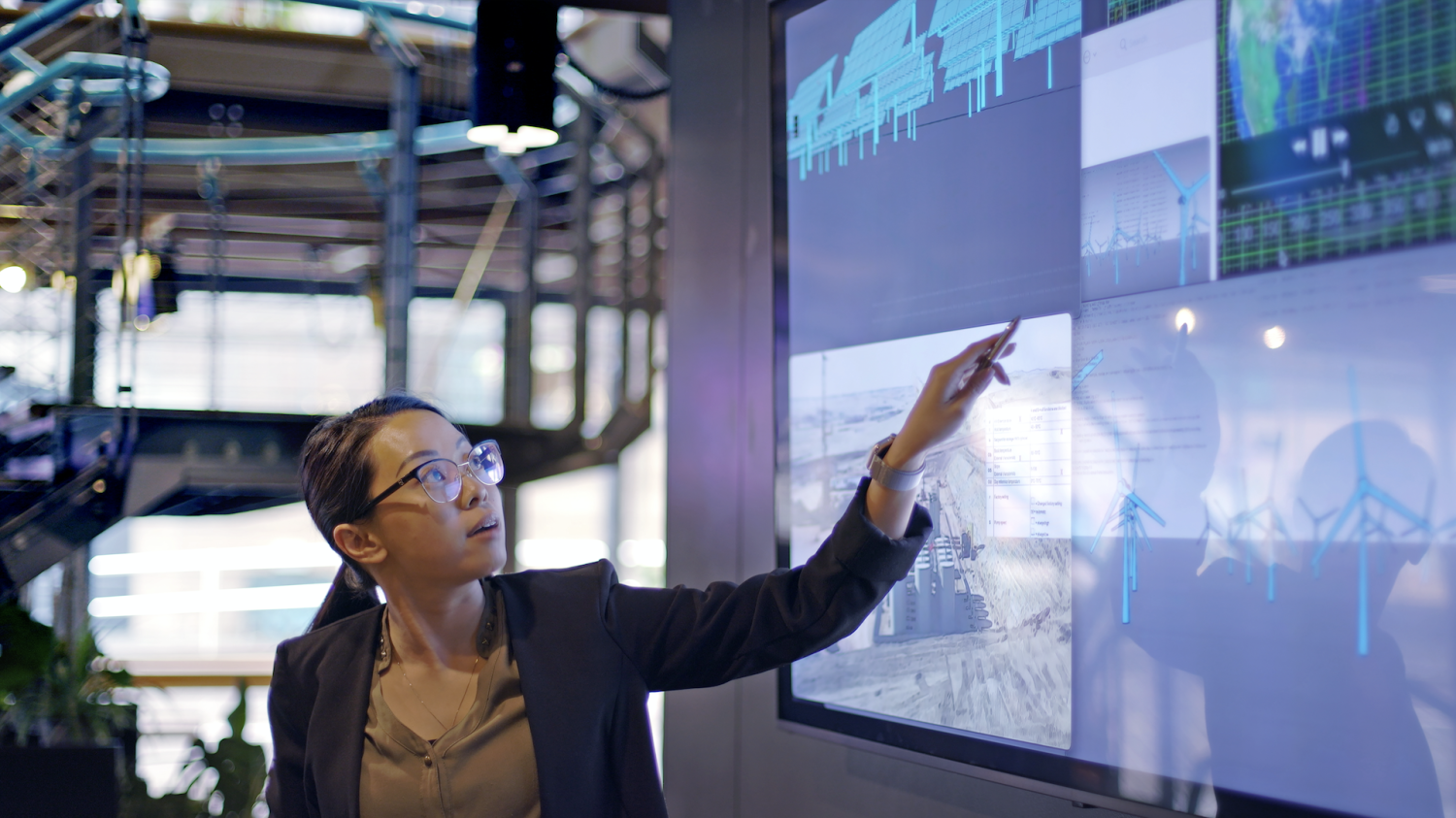 women at screen looking at business analytics data