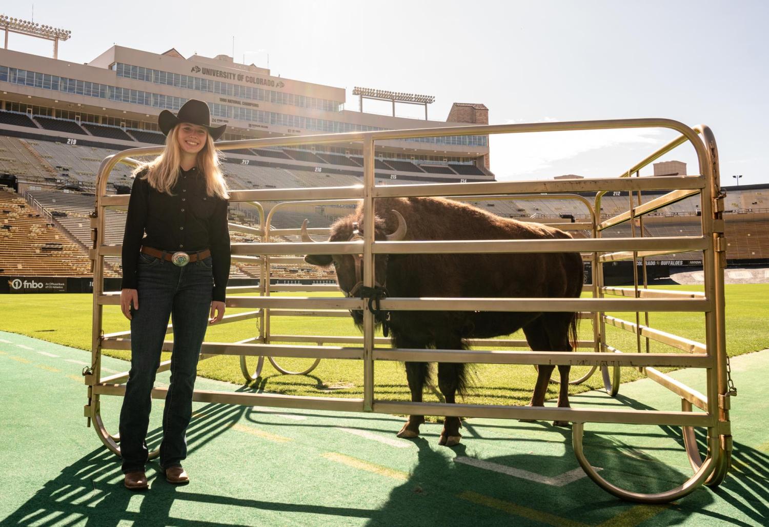 Sloan Hurley poses with a penned Ralphie on Folsom Field.