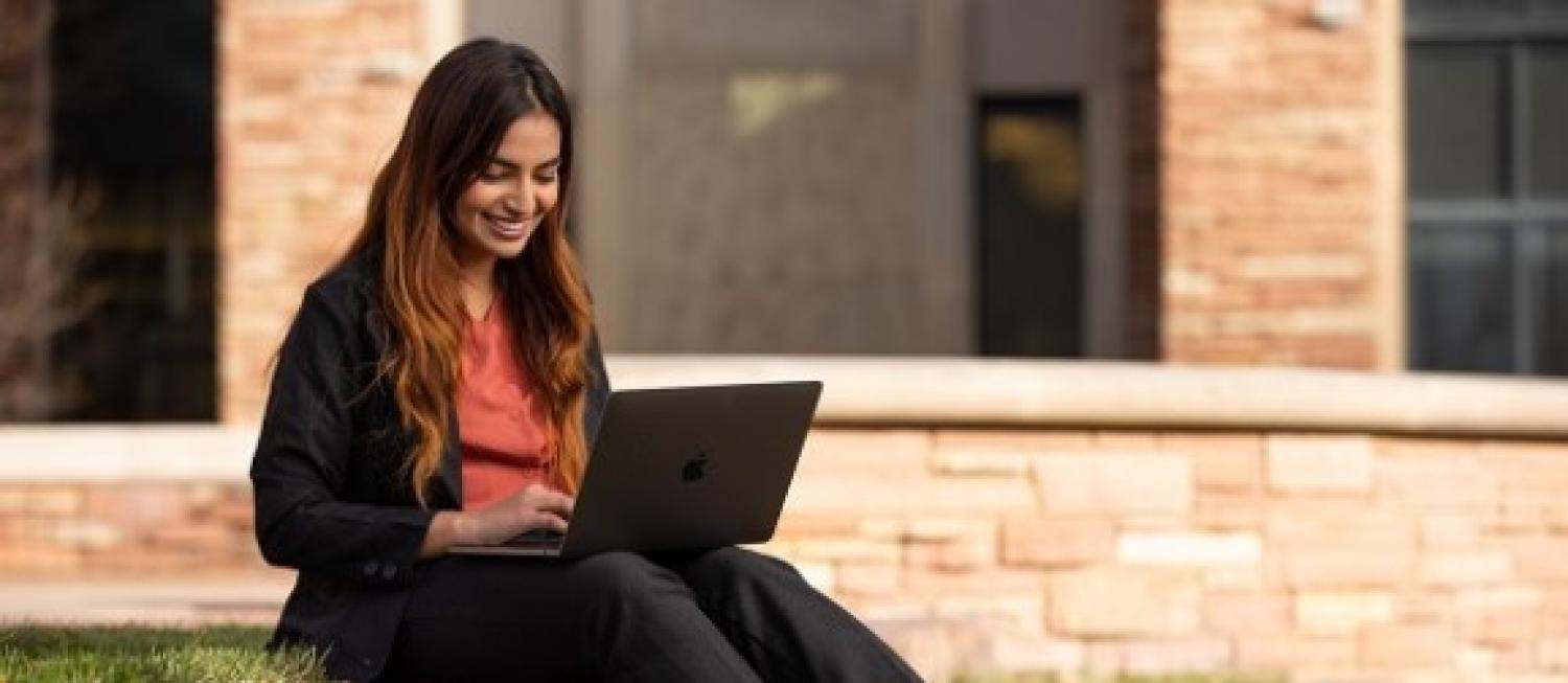student working outside on laptop