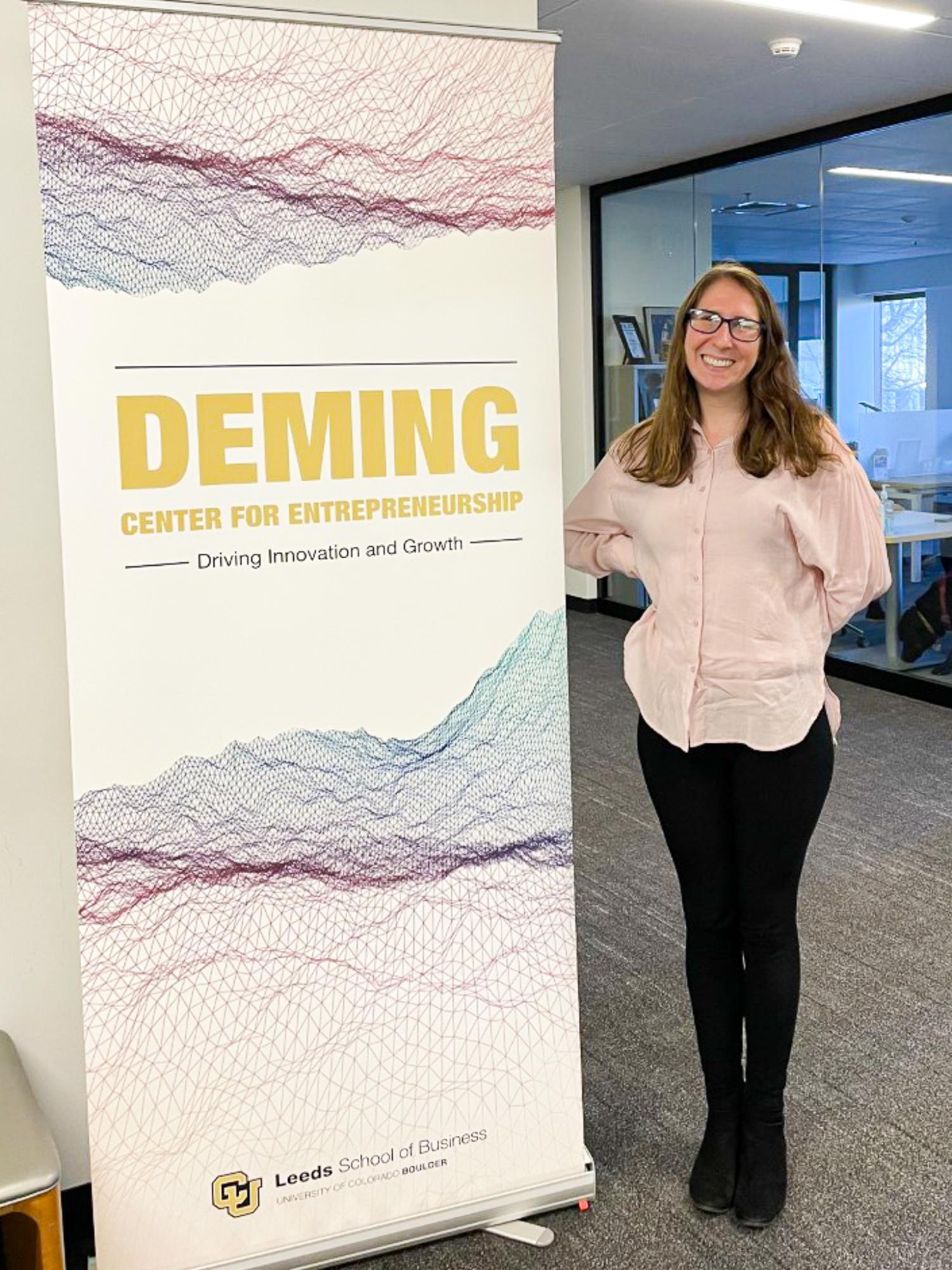 Alexis Grubman in front of the Deming Center for Entrepreneurship sign