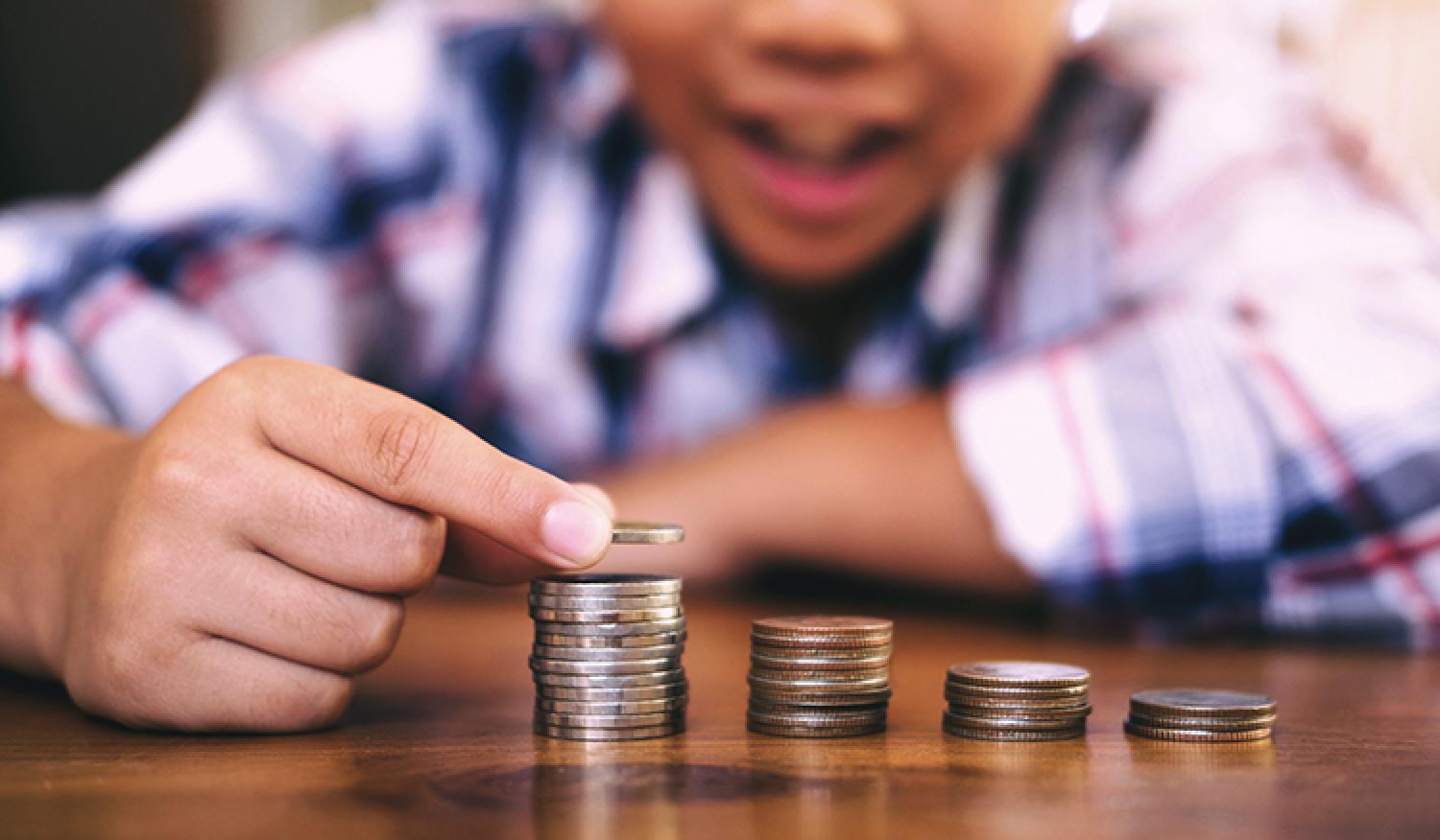 young-child-stacking-coins-banking-research