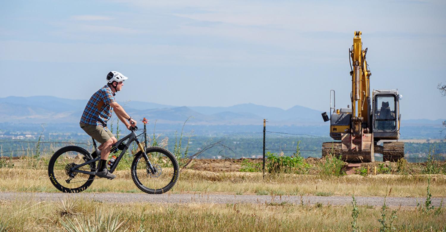 Jeff York riding his bike through the area devastated by the Marshall Fire.