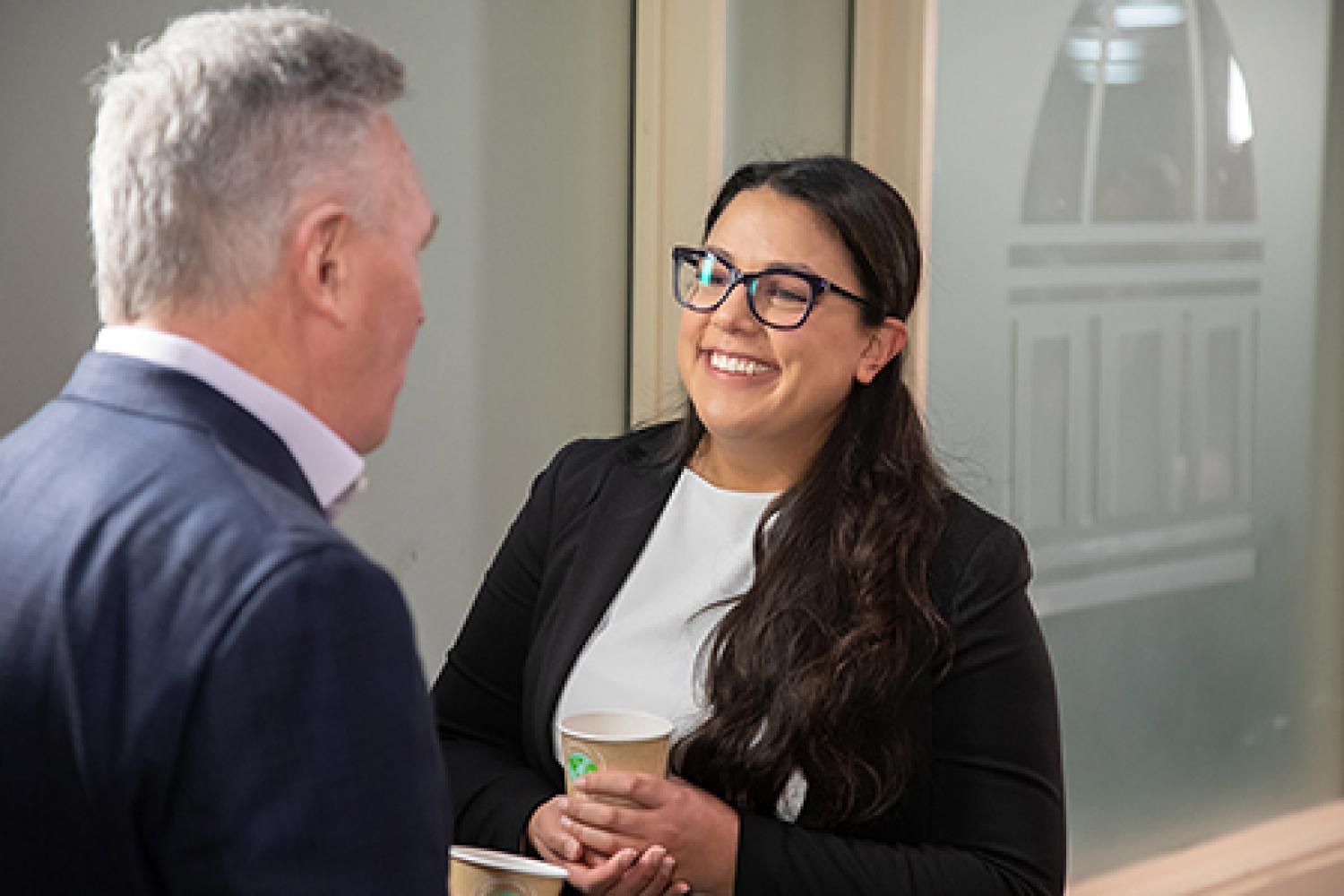 Two professionals networking in the Leeds building.