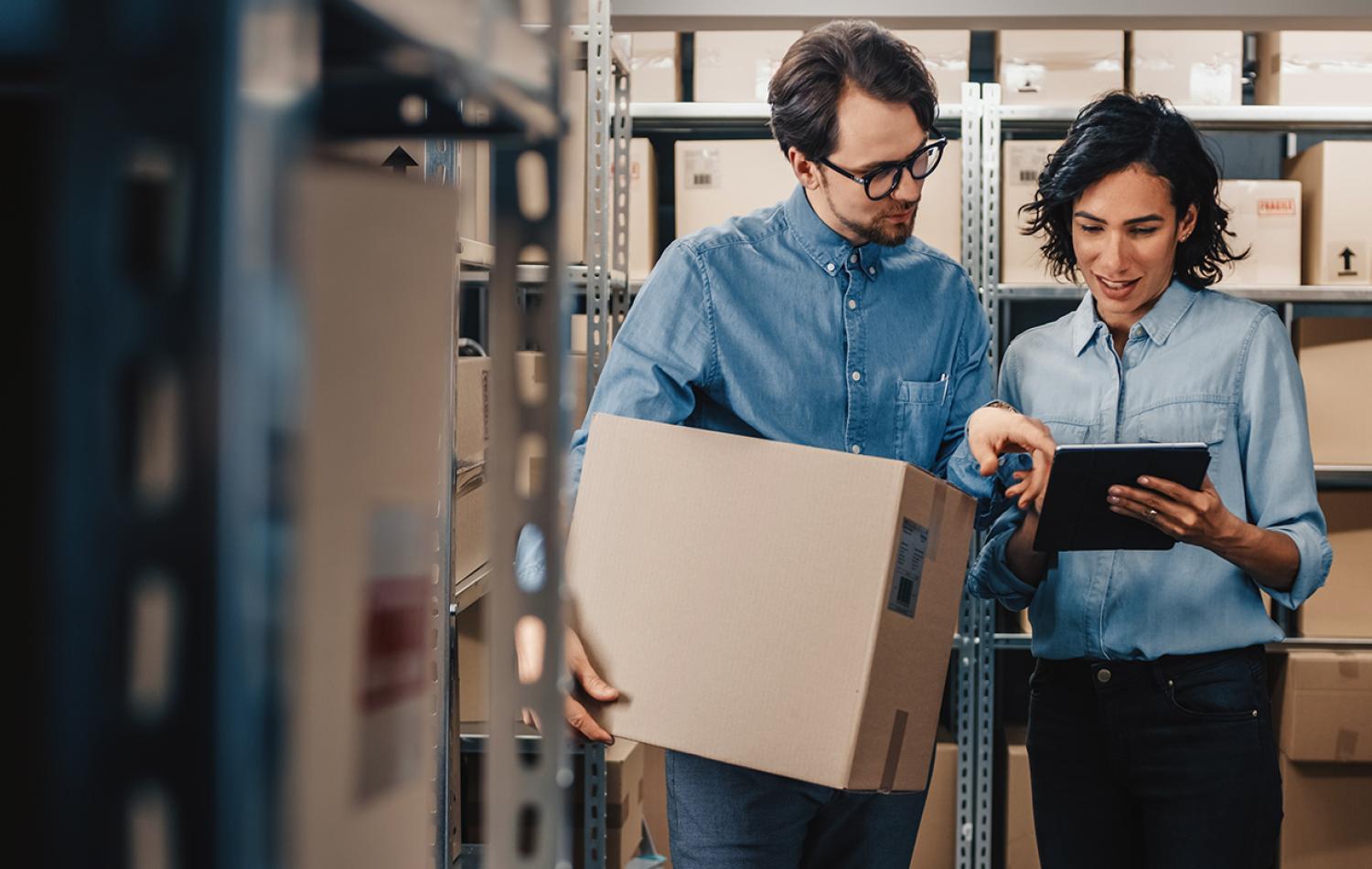 workers in a warehouse discussing supply chain issues