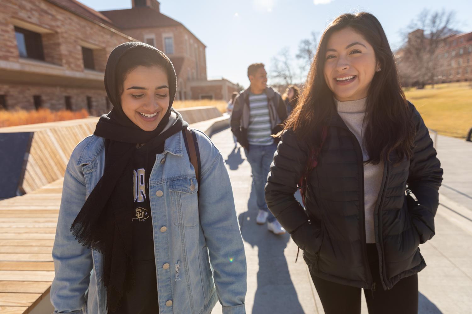 two girls walking and smiling outside
