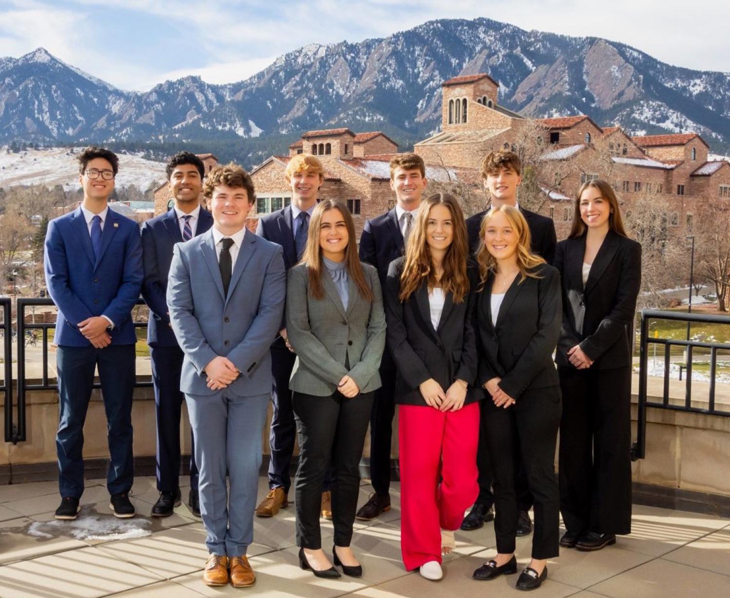 CU Real Estate Club members pose in front of the Flatirons