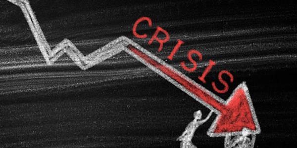 Sketch of a downward arrow with test the reads "crisis"
