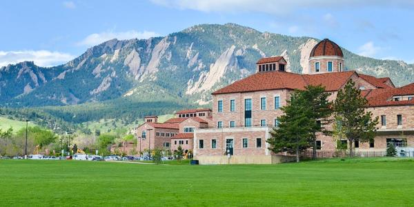 The Koelbel Building on the CU Boulder campus, with the Flatirons in the background.