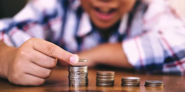 young-child-stacking-coins-banking-research