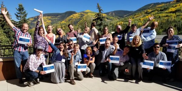 Rural Colorado Workshop participants standing in front of Colorado mountains in the fall