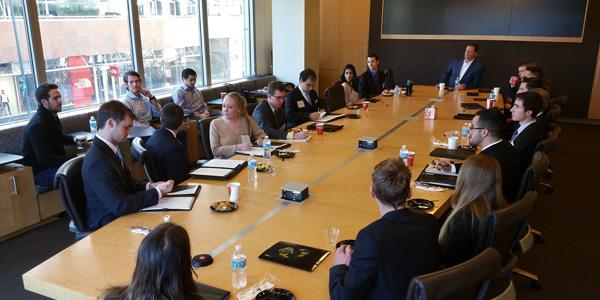 Burridge Center students on a financial trek and sitting in a board room