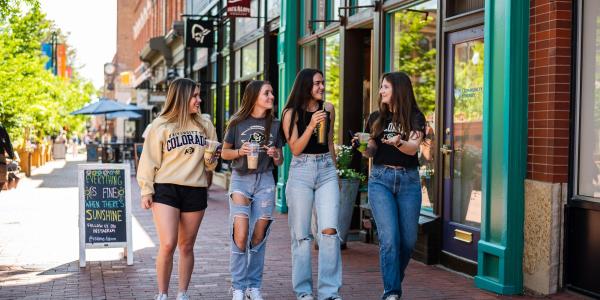 4 girls walking down pearl street