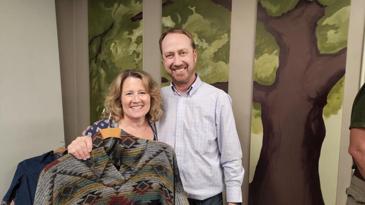 Sherri Picciano (right) and Erick Mueller (left) standing together holder some of Wester Wear's products.