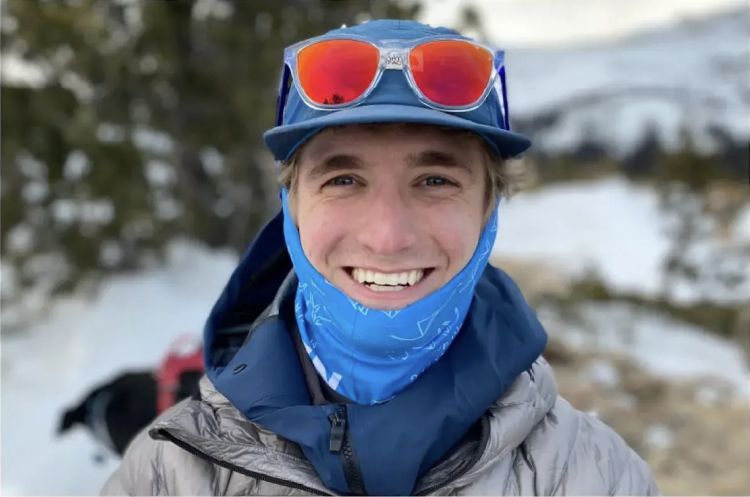 Luke Hatton smiles while wearing winter gear